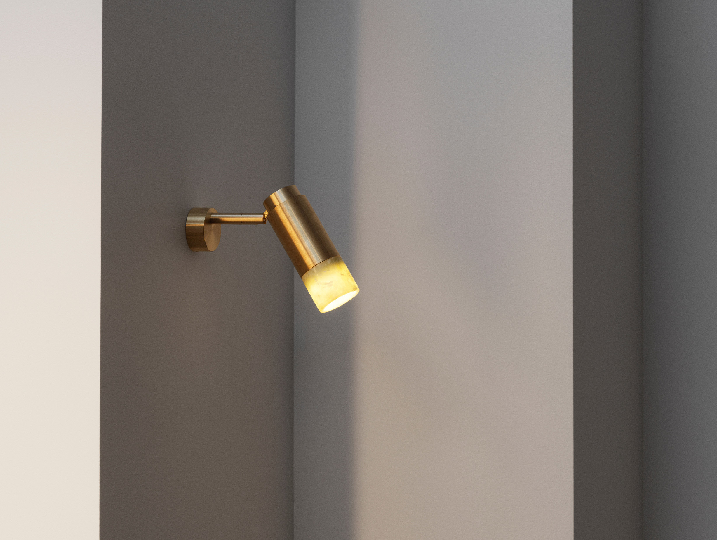 Anour donya pivot wall ceiling light brushed brass amber onyx lifestyle